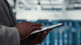 Close up of admin in data center workplace using tablet to calibrate energy usage. Server room IT specialist using device to inspect UPS configurations, doing maintenance on equipment - Powered by Shutterstock - Get 15% off with code: PIKWIZARD15