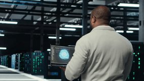 Technician using laptop in data center, managing server virtualization, running scripts. IT expert using programming language on notebook in server hub, finetuning network protocols, camera B - Powered by Shutterstock - Get 15% off with code: PIKWIZARD15