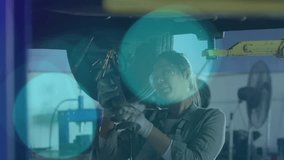 Female mechanic powering grinder under lifted car, generating sparks and smoothing suspension metal. Industrial, craftsmanship, tool, precision, manufacturing, ingenuity, grit - Powered by Shutterstock - Get 15% off with code: PIKWIZARD15