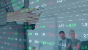 Businesswoman tapping device updating stock data overlay as office colleagues watching upward chart. Financial, analytics, technology, collaboration, professional, modern, growth - Powered by Shutterstock - Get 15% off with code: PIKWIZARD15