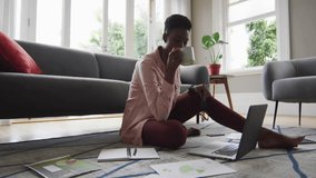 woman sipping mug glancing laptop, social media icons flooding around screen showing engagement. Content creator, remote work, digital communication, social media, home office, technology, lifestyle - Powered by Shutterstock - Get 15% off with code: PIKWIZARD15