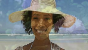 Modeling woman posing for fashion shoot on beach, drifting floral overlay over straw hat. Beachwear, tranquility, pastel, elegance, nature, beauty, serenity - Powered by Shutterstock - Get 15% off with code: PIKWIZARD15