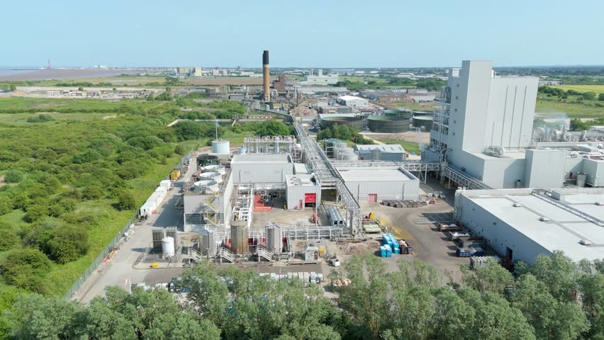 Industrial fibre factory with ventilation fans and chimneys captured by drone in England