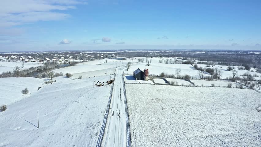 Flying over a farm road and a barn in Central Kentucky in winter