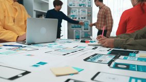 A diverse group of professionals engages in collaborative work on digital design and user experience strategies, surrounded by modern technology and creative tools. SACTR - Powered by Shutterstock - Get 15% off with code: PIKWIZARD15