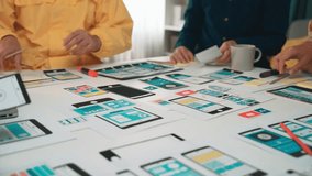 A diverse team works together in a modern workspace, innovating user interface design concepts with laptops, mockups, and digital tools, fostering creativity and collaboration. SACTR - Powered by Shutterstock - Get 15% off with code: PIKWIZARD15