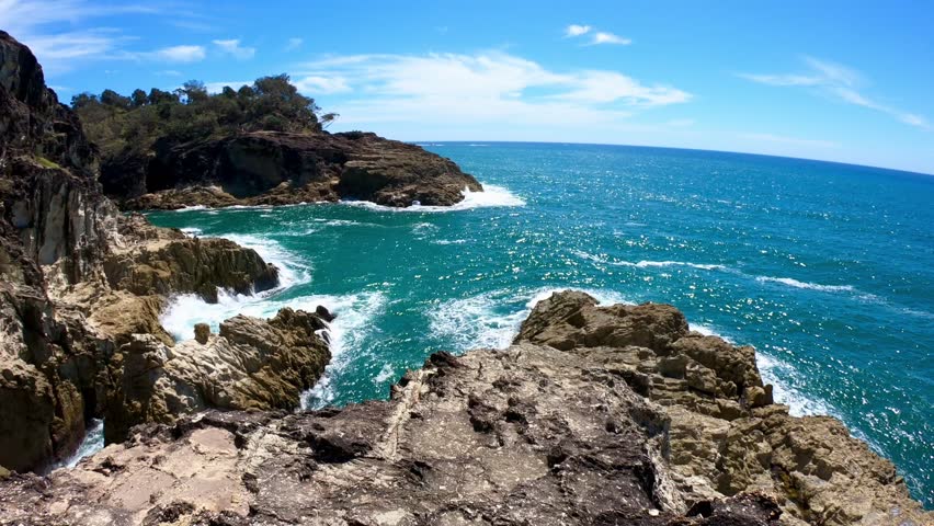 Rocky Coastal Cliffs with Ocean Waves and Blue Sky – Dramatic Seascape with Natural Rock Formations