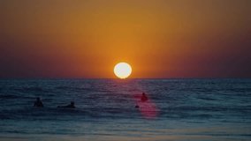Slow motion silhouettes of surfers at golden sunset, capturing coastal beauty in Costa Rica. - Powered by Shutterstock - Get 15% off with code: PIKWIZARD15