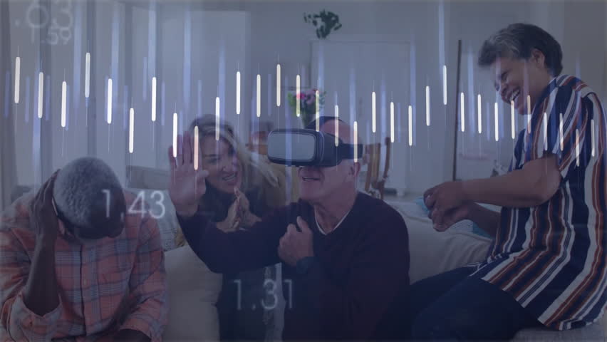 Senior man donning VR headset using controller as data graphs pulsing, friends celebrating in tech. Modern, interactive, immersive, camaraderie, digital, innovation, entertainment
