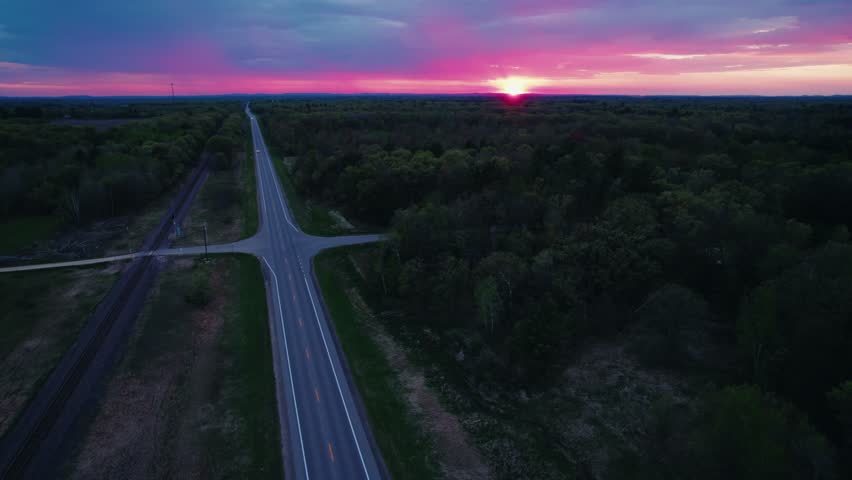 Aerial View of Marshfield Wisconsin Road and Railroad Intersection at Sunset with Glowing Sky
