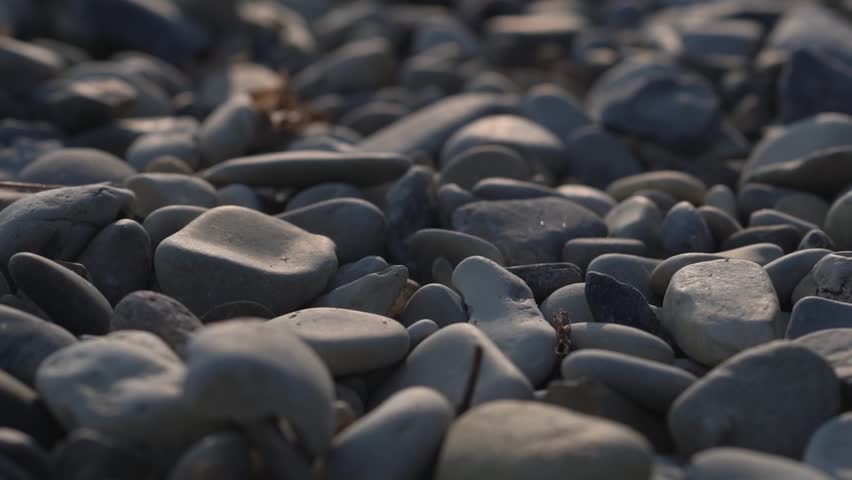 natural gray River Rock Pebbles stone Background. Gray large pebbles. Rocks on the beach. Extractive industry of natural resources