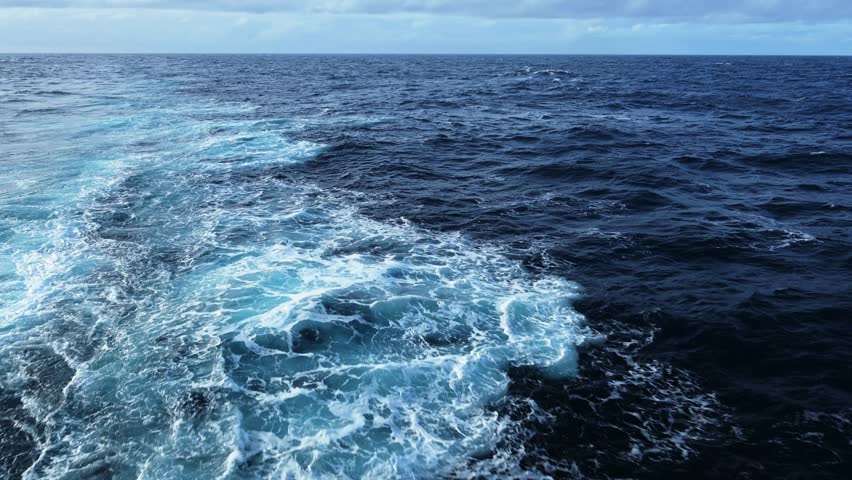Open Ocean Ship View and Horizon, Gentle Rolling Swell of Waves and Sea Water with Clouds in Cloudy Weather, Vast Endless Sea Background with Copy Space from Moving Boat Cruise Ship Trip