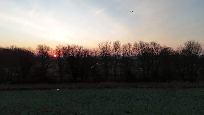 Aerial sunrise video over fields near Rotterdam and Berkel en Rodenrijs, showing an aircraft near Rotterdam The Hague Airport. Captured on February 18, 2025 at 07:58.