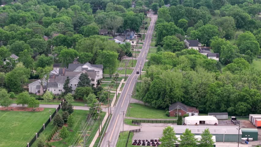 Tracking Aerial Shot Of A Car Driving Through A Rural Community In Franklin, Nashville, Tennessee.