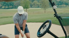 A male golfer hits an iron off the fairway in slow motion. The shot is framed from a partner POV angle through a golf cart, creating a unique, immersive view of the swing and impact. - Powered by Shutterstock - Get 15% off with code: PIKWIZARD15