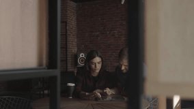 Man and woman discuss business strategy on tablet in modern cafe. Teamwork, digital device use - Powered by Shutterstock - Get 15% off with code: PIKWIZARD15