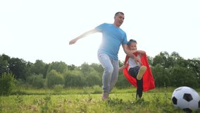 Father and son playing with soccer ball. Soccer father and son playing on grassy field. A couple of young people bonding on the beach in a casual cape. A father and his son are kicking lifestyle. - Powered by Shutterstock - Get 15% off with code: PIKWIZARD15