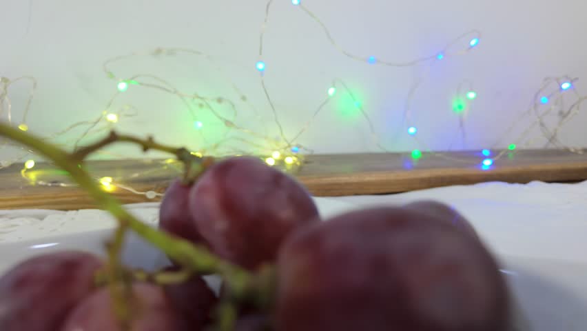 Traditional Venezuelan Christmas dish with ham bread, olives, grapes and festive lights