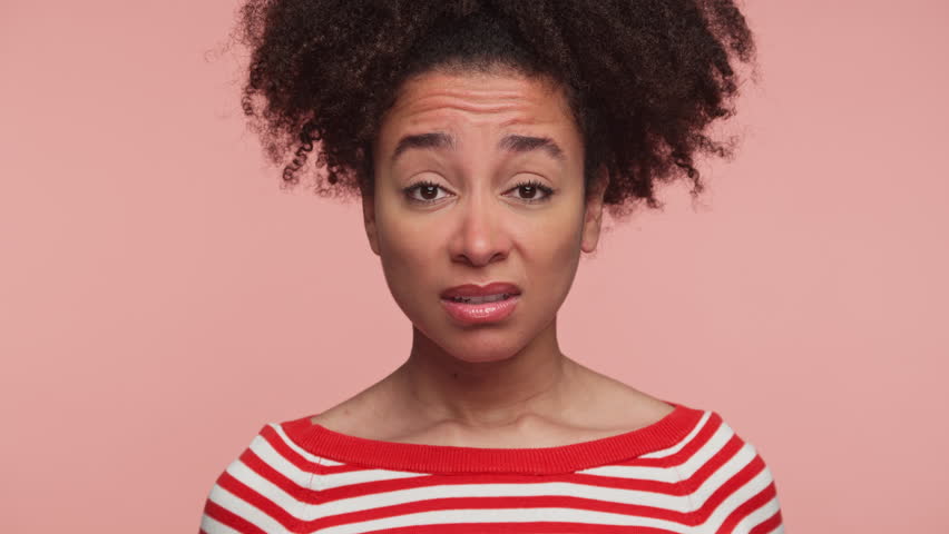Shocked woman reacting to unexpected bad news on pink background