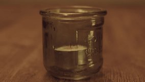 Tealight Candle Extinguished in Glass Jar on Wooden Table with Warm Ambient Lighting - Powered by Shutterstock - Get 15% off with code: PIKWIZARD15