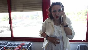 Pregnant manager experiencing stomach discomfort during phone call - Powered by Shutterstock - Get 15% off with code: PIKWIZARD15