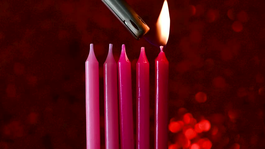 Pink birthday candles with red sparkling red background. Candles for cake, celebrating birthday