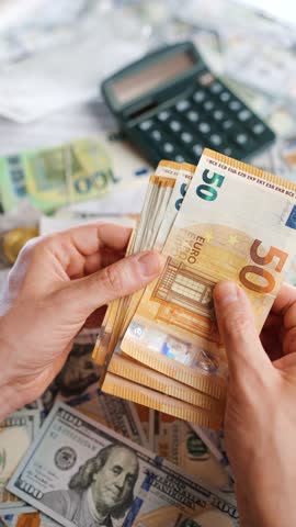 Man calculating money, monthly home expenses, taxes and bank account balance.