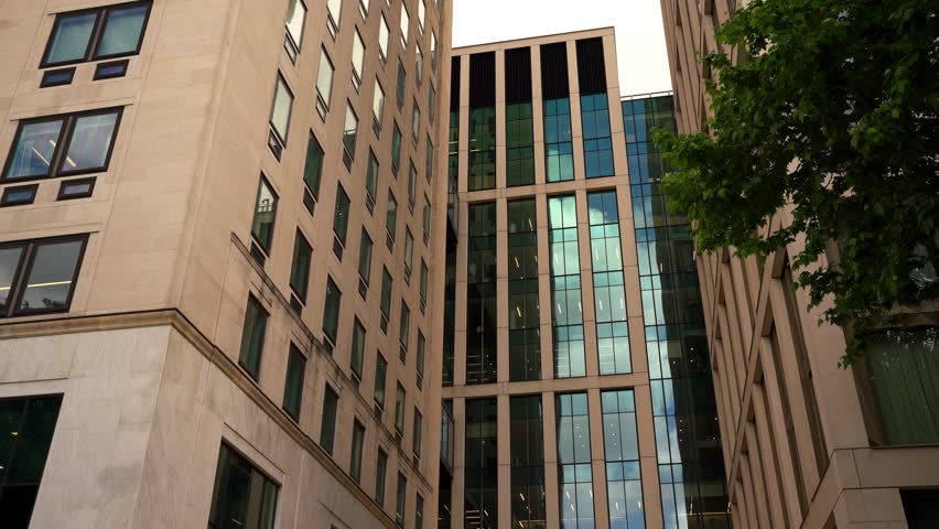 Modern exterior of corporate office buildings in an urban setting. Ideal for business, finance, real estate, and professional themes. - Powered by Shutterstock - Get 15% off with code: PIKWIZARD15