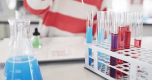 Young girl conducting colorful chemistry experiment with test tubes in science class, at school. education, laboratory, learning, research, classroom - Powered by Shutterstock - Get 15% off with code: PIKWIZARD15