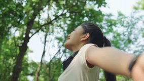 Asian woman exercising, breathing fresh air while exercising in bright nature, relaxation, resting, feeling refreshed. - Powered by Shutterstock - Get 15% off with code: PIKWIZARD15