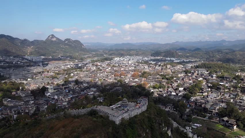 Discover the breathtaking aerial panorama of Qingyan Ancient Town in Guizhou, where rich history meets stunning landscapes. Enjoy the blend of ancient architecture and nature