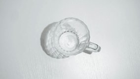 A man is pouring dark beer into a mug on a white background. The beer comes from a bottle with a cork. swing-top bottle and flip-top bottle. - Powered by Shutterstock - Get 15% off with code: PIKWIZARD15