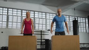 workout partners initiating box jumps in gym, syncing movements while emojis boosting engagement. Fitness, strength, motivation, training, athleticism, motion, teamwork - Powered by Shutterstock - Get 15% off with code: PIKWIZARD15
