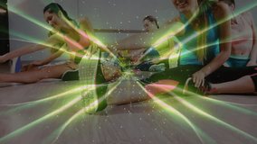 Fitness instructor initiating seated routine on mats with class mirroring torso twists for mobility. Stretching, flexibility, group exercise, wellness, dynamic, balance, movement - Powered by Shutterstock - Get 15% off with code: PIKWIZARD15