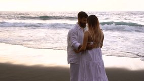 Happy couple having tender moment and dancing together on the beach during summer vacation - Pregnancy, relationship bonding and family concept  - Powered by Shutterstock - Get 15% off with code: PIKWIZARD15
