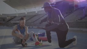 Athlete using foam roller on track, coach tapping tablet, tech metrics animating optimizing form. Performance, rehabilitation, biomechanics, fitness, motivation, innovation, training - Powered by Shutterstock - Get 15% off with code: PIKWIZARD15