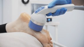 Foot shockwave therapy session in medical clinic - Powered by Shutterstock - Get 15% off with code: PIKWIZARD15