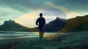 Animated Brazilian flag appearing, man walking along beach raising arms celebrating travel. Patriotism, achievement, perseverance, adventure, landscape, nature, confidence - Powered by Shutterstock - Get 15% off with code: PIKWIZARD15