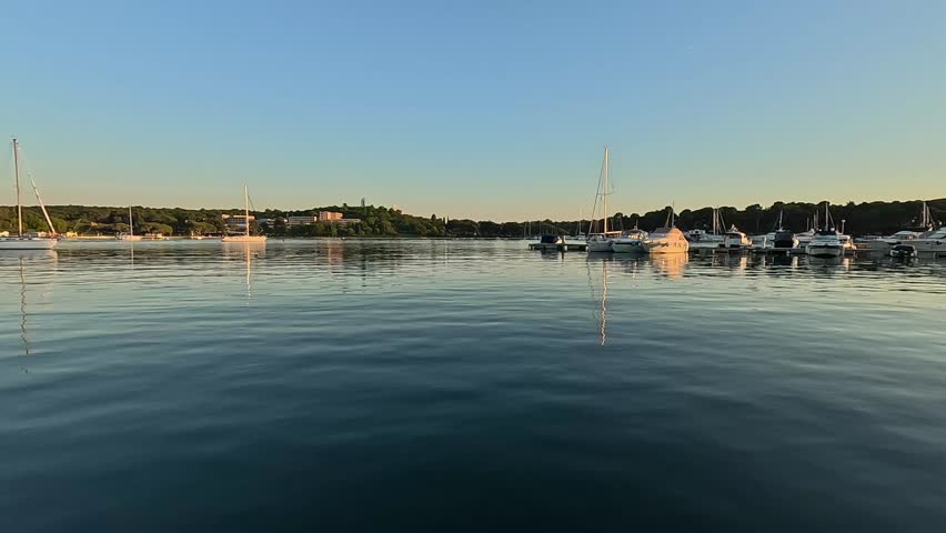 Panoramic view of a marina with yachts and sailboats on the shore in croatia at sunset, concept of travel, luxury tourism, mediterranean lifestyle.
