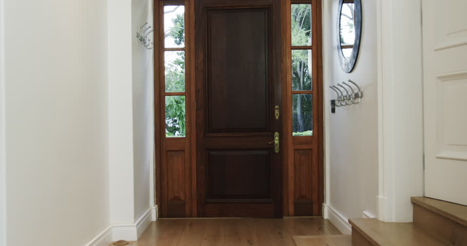 Asian man entering home with playful dog on leash, smiling happily. Pets, companionship, indoors, happiness, lifestyle, animal