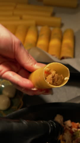 Close-up of Stuffing Cannelloni with Meat – Female Hands