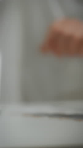 A pharmacy worker assists a customer by handing over a box of medicines. This interaction takes place in a local pharmacy during working hours, showcasing healthcare service