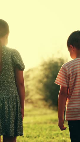 Children friends boy girl playing together in park holding hands. Children teamwork, group of kids, relaxing in park. Friends together outdoors. Success, children friendship concept. Boy, girl in