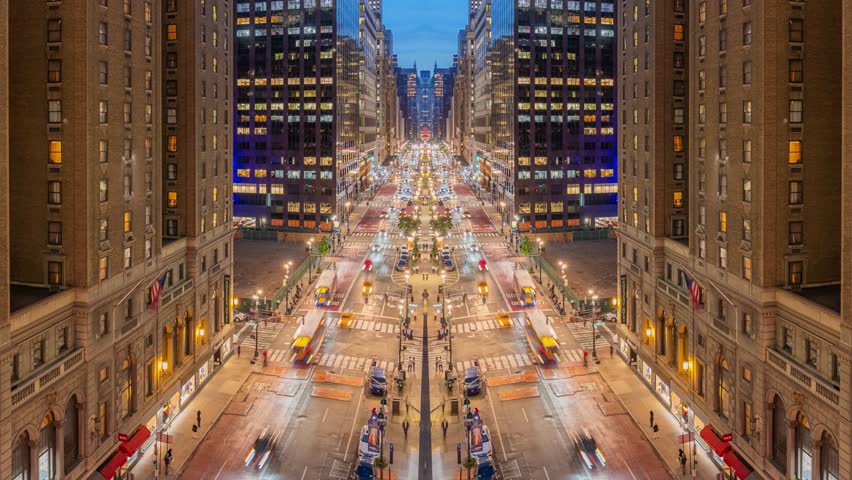 Aerial drone view of New York City urban overpass and illuminated streets at night showcasing traffic flow, dense city infrastructure, glowing lights, and modern architecture in cinematic style.
