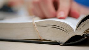 Feminine hand trace Bible scripture and religion. Holy book rests open. Finger moves over sacred text. Deep study of divine words. Christian faith and spiritual understanding - Powered by Shutterstock - Get 15% off with code: PIKWIZARD15