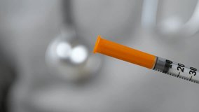 Doctor hand steadies syringe and vial to prepare medication. Preventive medicine concept. Immunization strategies for reducing disease spread - Powered by Shutterstock - Get 15% off with code: PIKWIZARD15