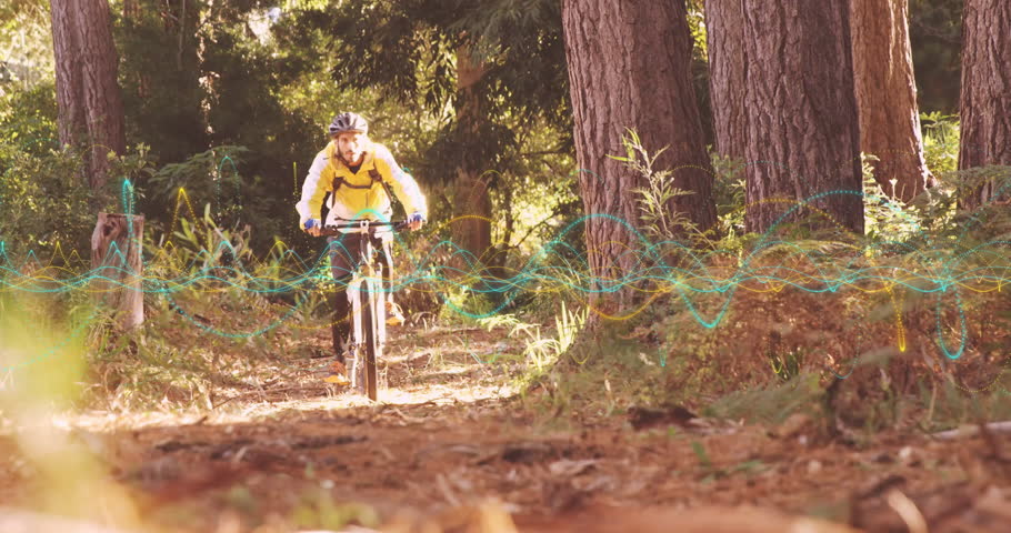 Cyclist pedaling mountain bike forest trail, camera zooming and displaying wavelike tech overlay. Adventure, outdoor, eco, energetic, dynamic, vibrant, exploration