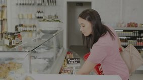 Shopper entering grocery store selecting item while comparing price charts overlaying glass case. Retail, consumer, digital, analytics, modern, trendy, healthy - Powered by Shutterstock - Get 15% off with code: PIKWIZARD15
