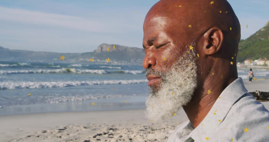 Man sitting cross-legged on beach inhaling golden star particles rising for health meditation. Meditation, tranquility, mindfulness, spiritual, serenity, wellness, nature