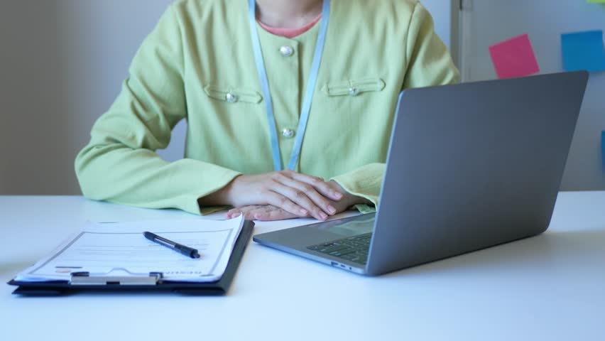 Young businesswoman holds a resume and evaluates it. Views the personal history of job applicants. Recruitment concept